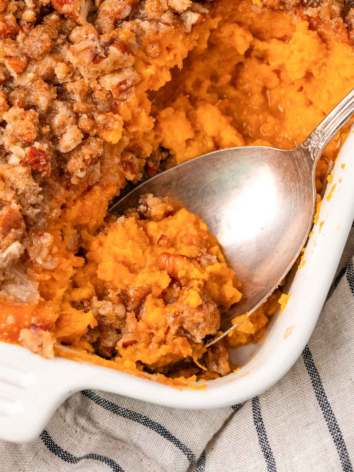 Sweet Potato Casserole with Pecans beside the Main Plate