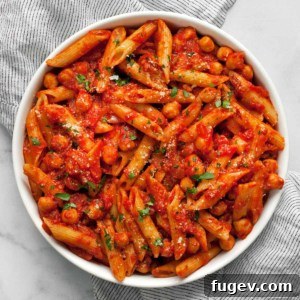 Arrabbiata Penne with a Chickpea Twist 8 Pasta with chickpeas and spicy tomato sauce in a bowl.