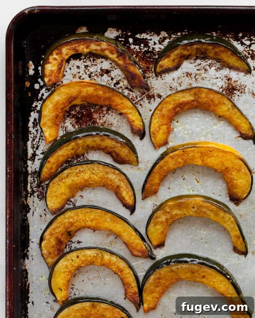 Hearty Acorn Squash and Chickpea Quinoa 6 Roasted acorn squash slices arranged on a sheet pan, ready for the oven
