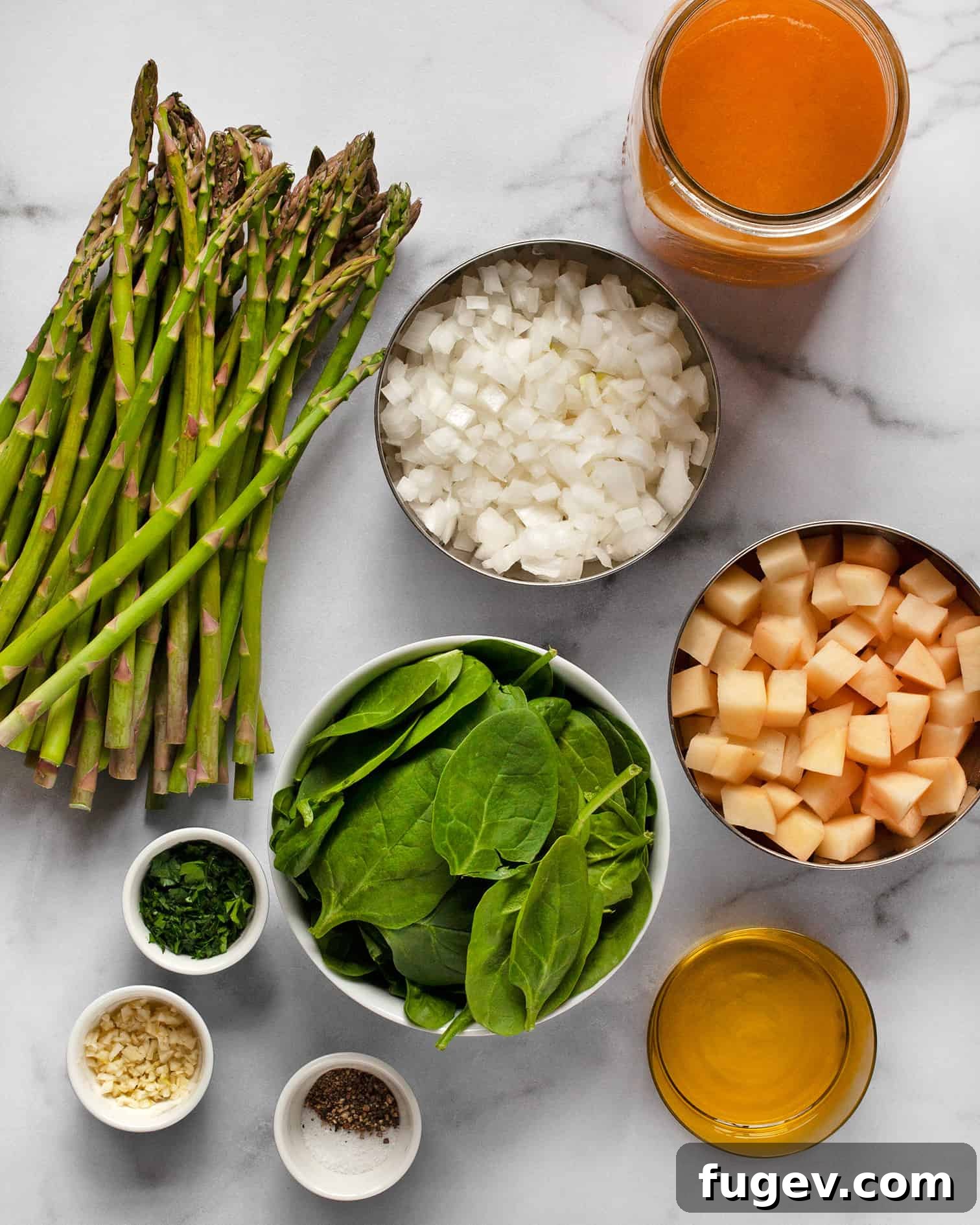 Silky Roasted Asparagus Soup 3 Assortment of fresh ingredients including asparagus, spinach, onions, potatoes, and vegetable broth.