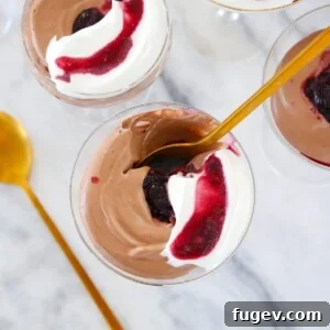 Chocolate Mousse in glass with gold spoon.