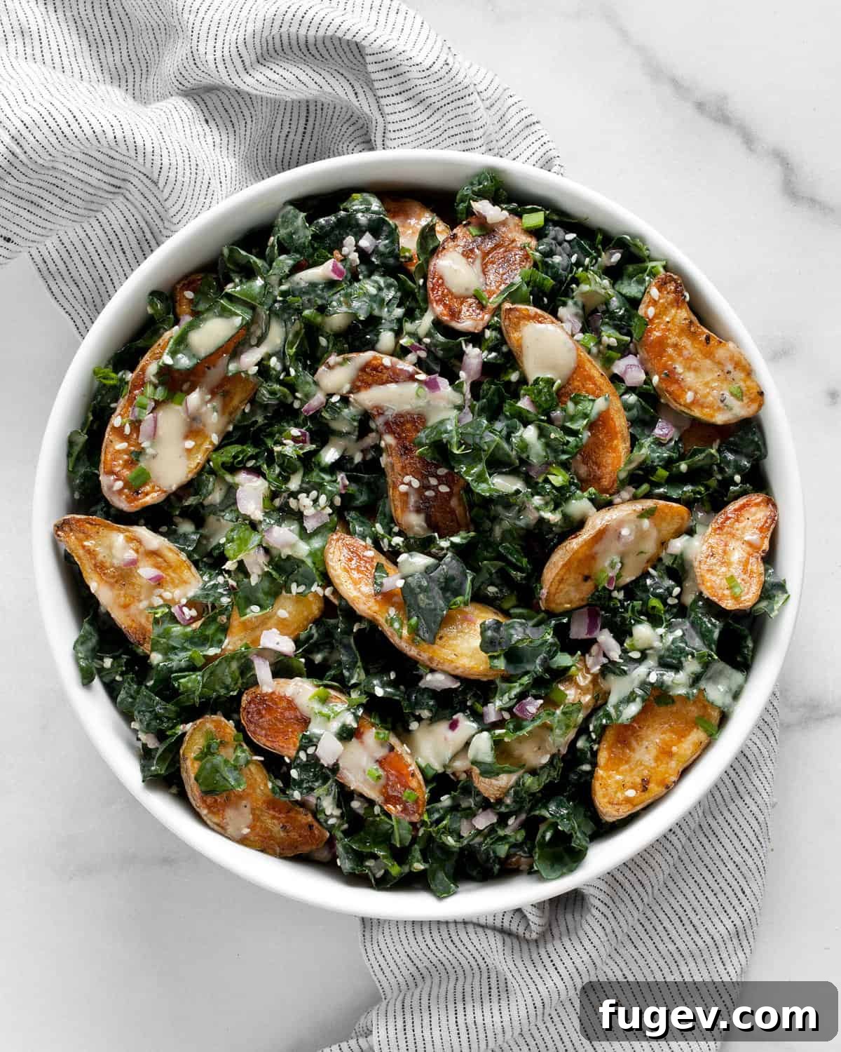 Emerald & Gold Potato Salad 2 A vibrant bowl of roasted fingerling potato and kale salad, beautifully plated and ready to serve.