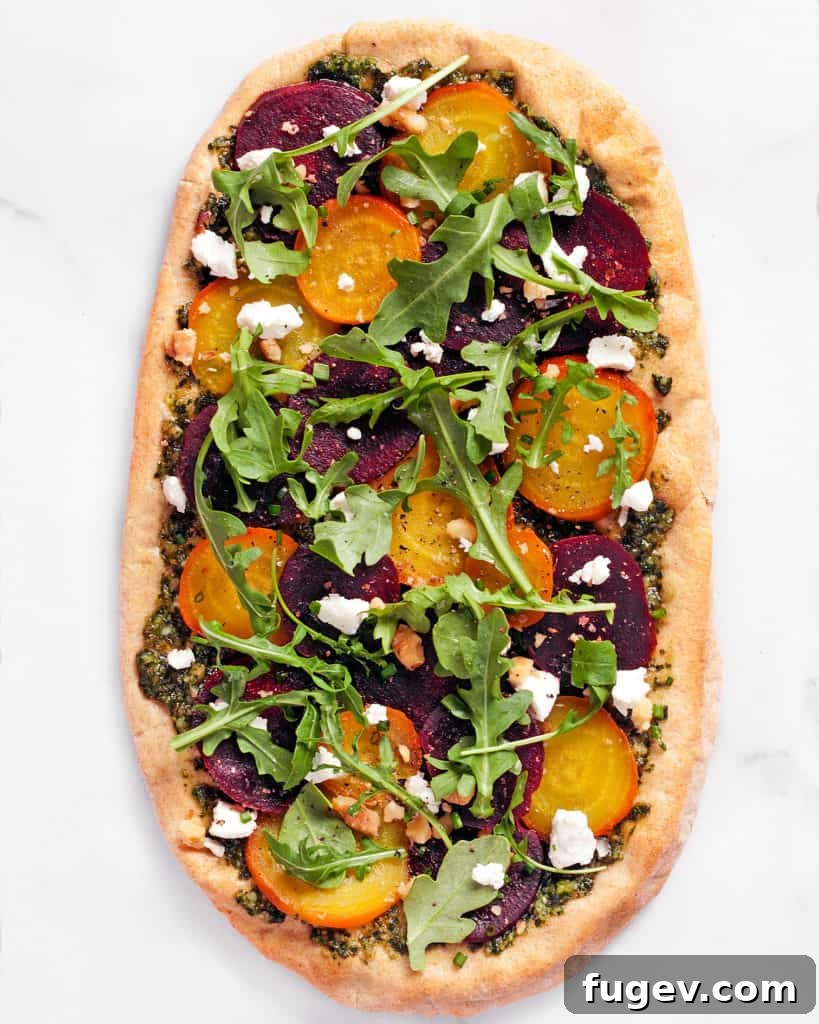 Vibrant Beet & Goat Cheese Flatbread 3 Close-up shot of roasted beet flatbread showing layers of beets, pesto, and cheese