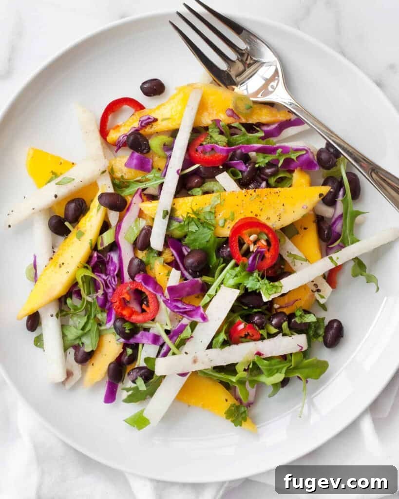 Tropical Mango Jicama Black Bean Medley 3 Close-up of mango spears and jicama matchsticks in a black bean salad