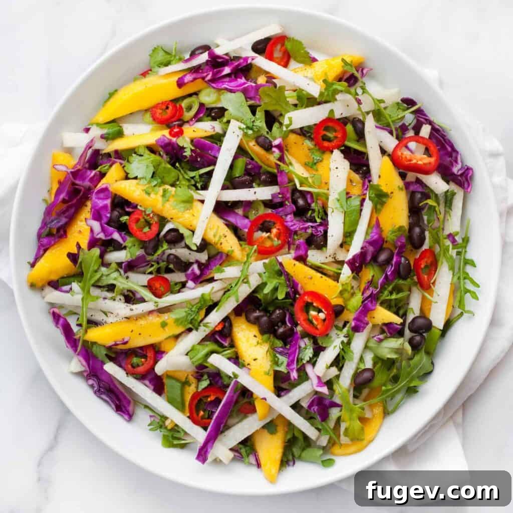 Tropical Mango Jicama Black Bean Medley 5 Overhead shot of the finished Mango Jicama Black Bean Salad with lime wedges