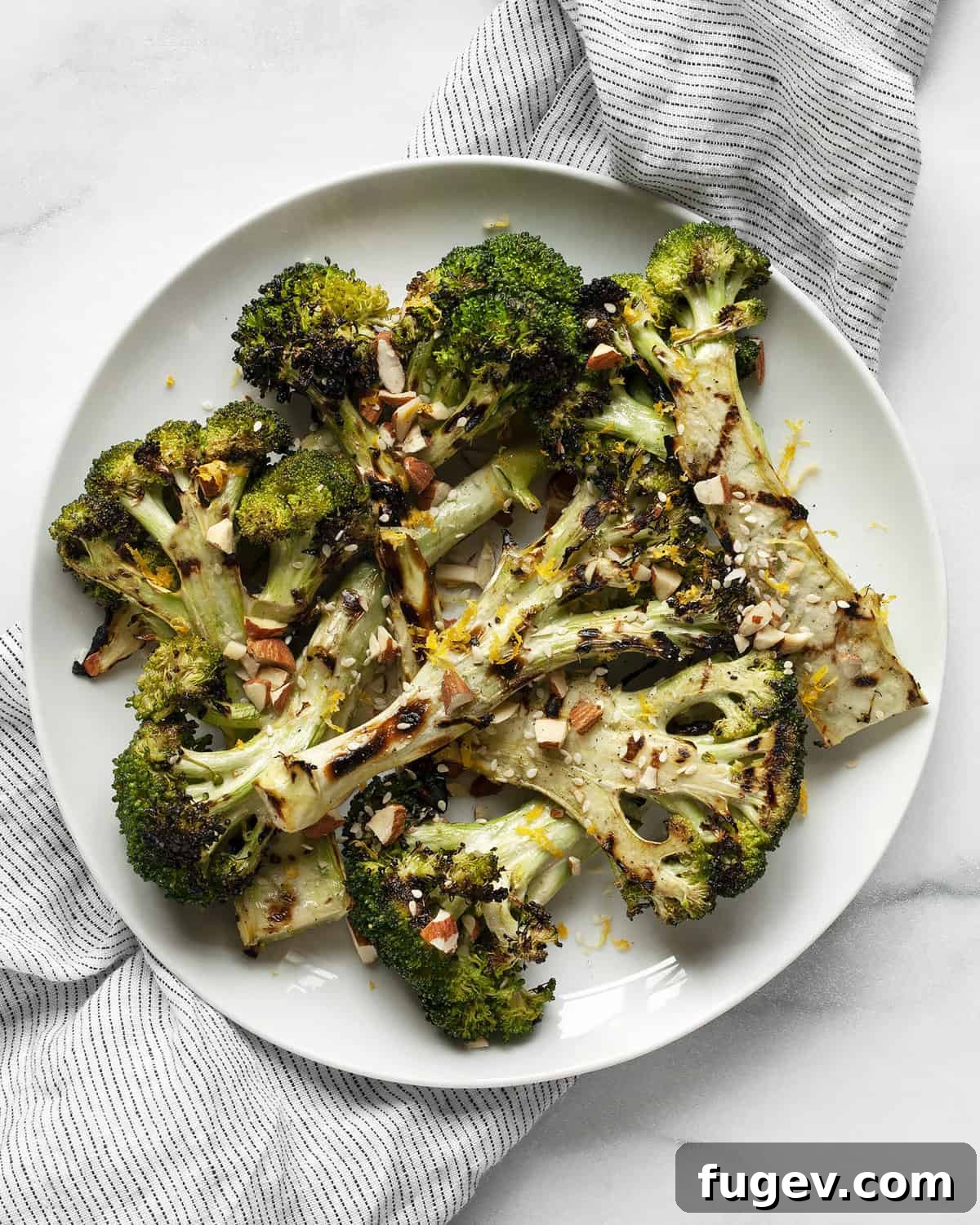 Smoky Lemon-Kissed Broccoli 7 Close-up of vibrant lemon grilled broccoli on a plate, garnished with the nut-seed mix and lemon zest.