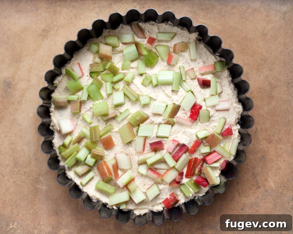 Blissful Rhubarb Almond Cake 4 Fresh rhubarb stalks on a cutting board, ready for baking