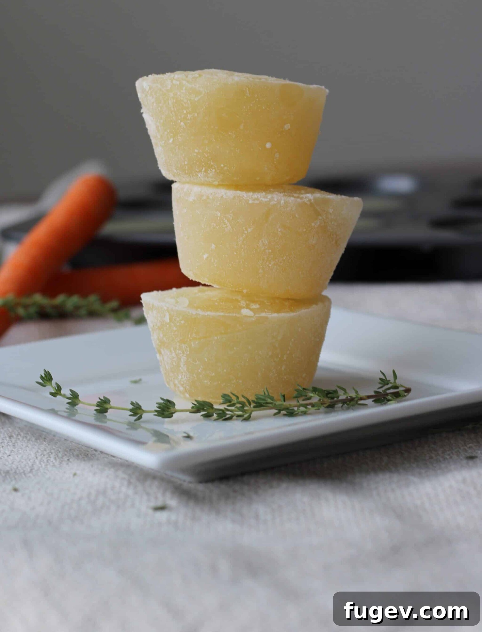 Mastering the Art of Golden Chicken Broth 4 Homemade chicken broth perfectly frozen and stacked in individual cupcake-sized portions.