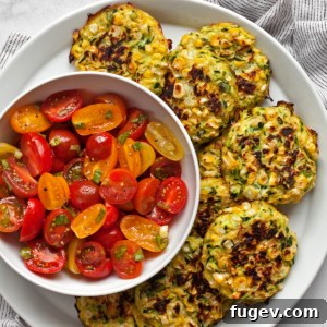 Finished zucchini corn fritters with tomato salad