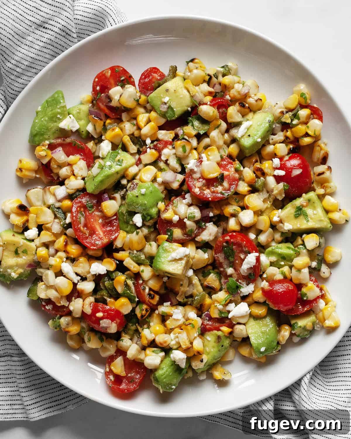 Zesty Avocado Corn Salad 2 Grilled corn avocado salad in a bowl.