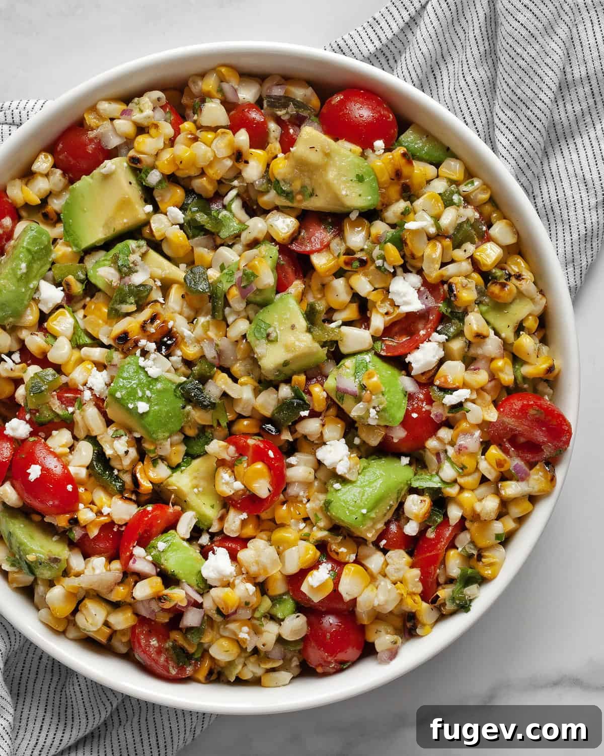Zesty Avocado Corn Salad 7 Corn salad with avocados in a bowl.