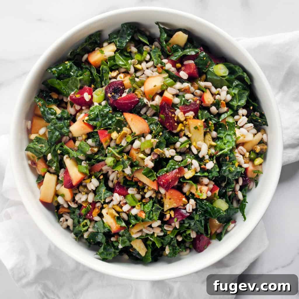 Sweet & Savory Stone Fruit Barley Kale Bowl 5 A serving of Stone Fruit Kale Barley Salad in a bowl, showing the mix of ingredients.