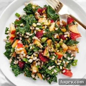 Close-up of Stone Fruit Kale Barley Salad in a serving bowl, showcasing the colorful ingredients.