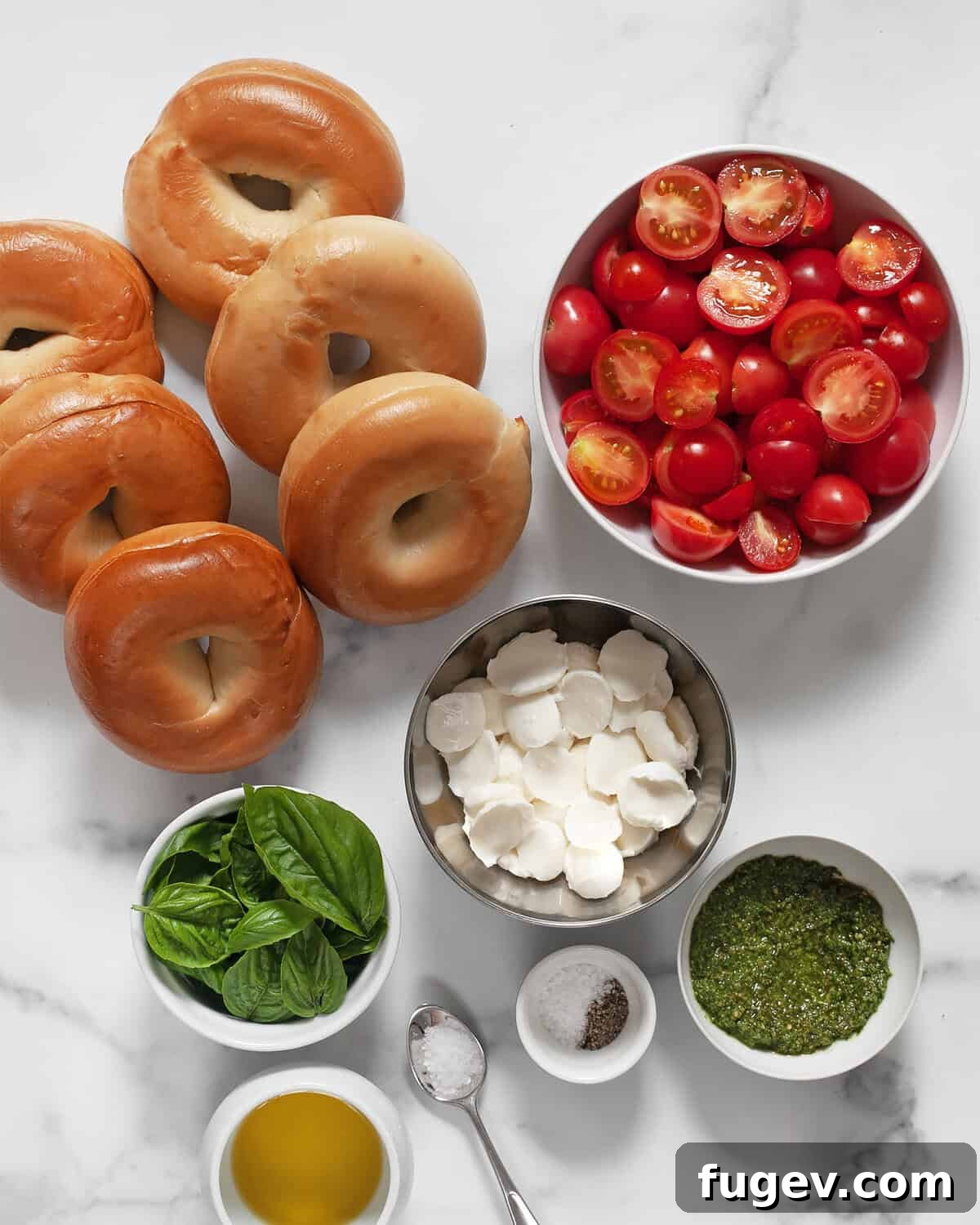 Fresh Caprese Bagel 3 Ingredients including bagels, roasted cherry tomatoes, sliced mozzarella, fresh basil, vibrant pesto, extra virgin olive oil, kosher salt, black pepper, and flaky sea salt.