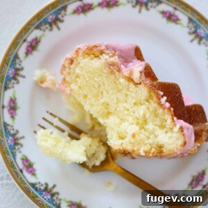 Lemon Pound Cake with Strawberry Icing on vintage china, ready to be enjoyed.