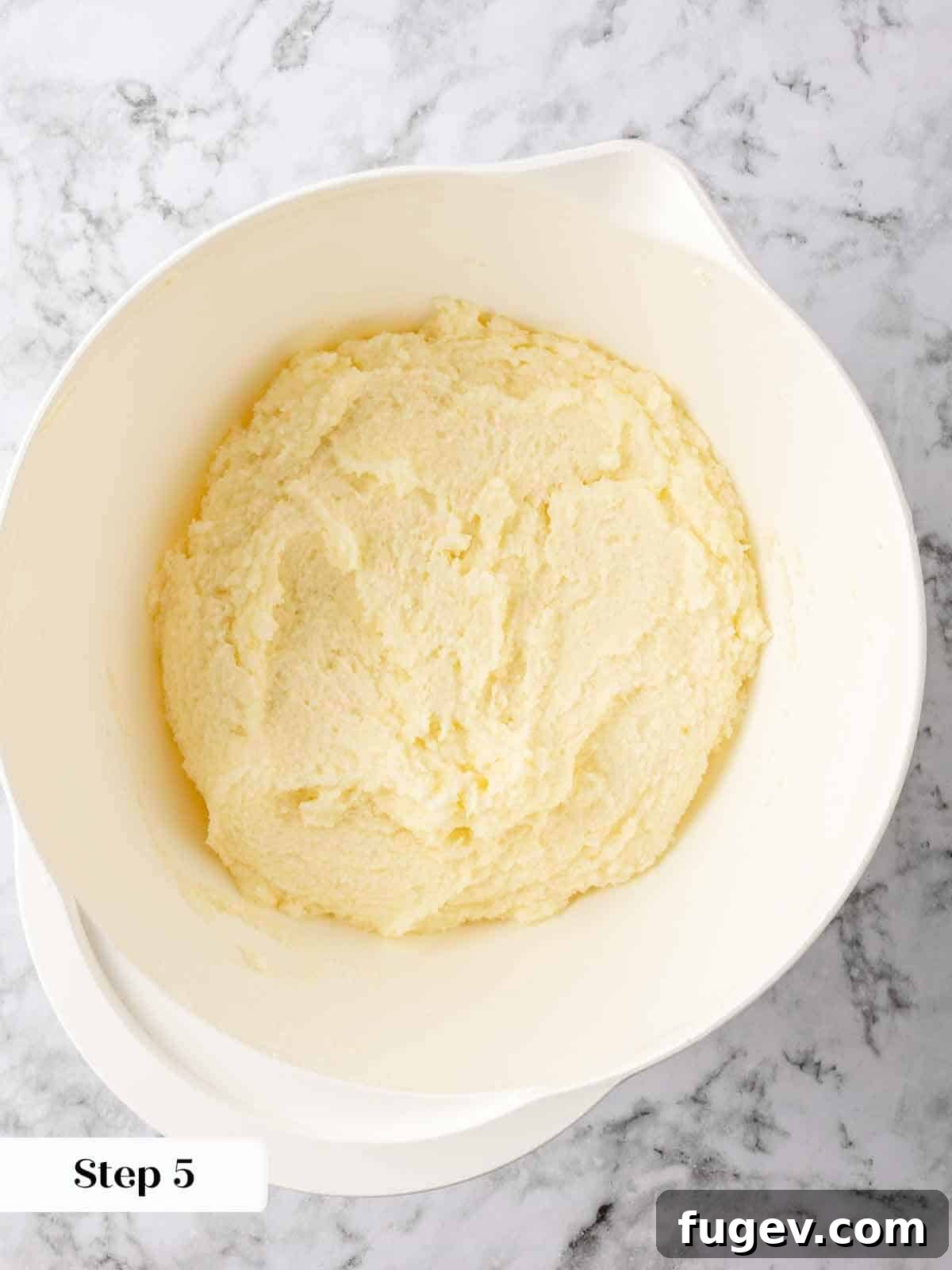 Zesty Lemon Loaf 5 The process of creaming butter and sugar into a smooth paste, essential for the dense texture of lemon pound cake.