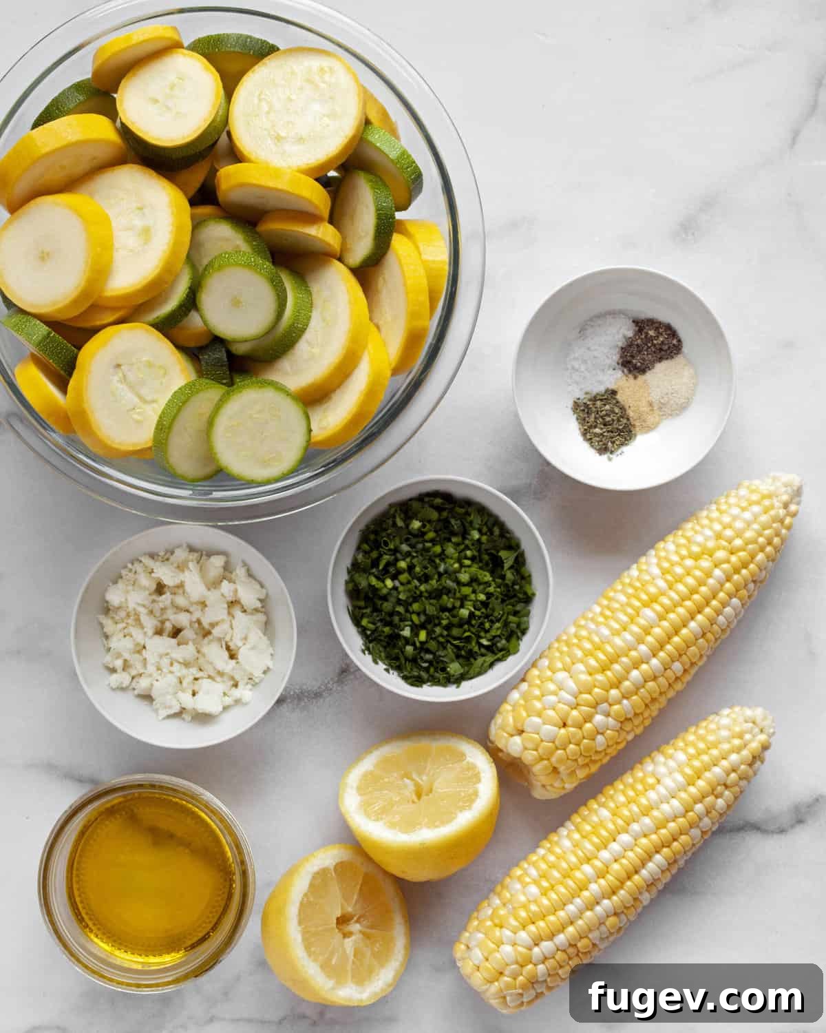 Summer Grilled Veggie Medley 3 Ingredients for grilled zucchini and squash with corn, including fresh herbs, feta, olive oil, and spices on a wooden board.