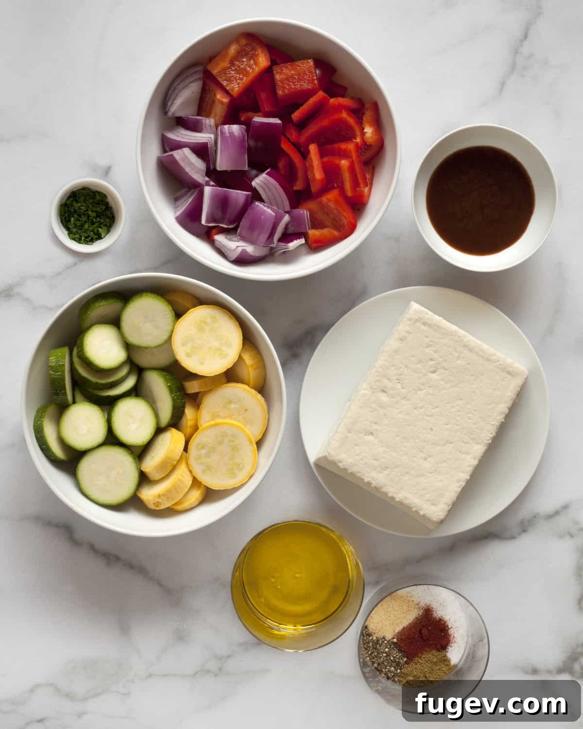 Smoky Tofu and Vibrant Veggie Skewers 3 Close-up shot of key ingredients for BBQ tofu veggie skewers including firm tofu, barbecue sauce, a mix of fresh vegetables, olive oil, and various spices.
