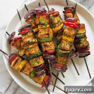 Delicious BBQ tofu veggie skewers stacked beautifully on a plate, ready to be enjoyed.