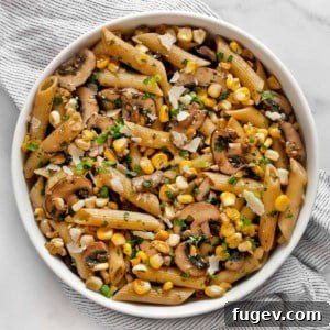 Mushroom corn penne in a bowl, ready to be served.