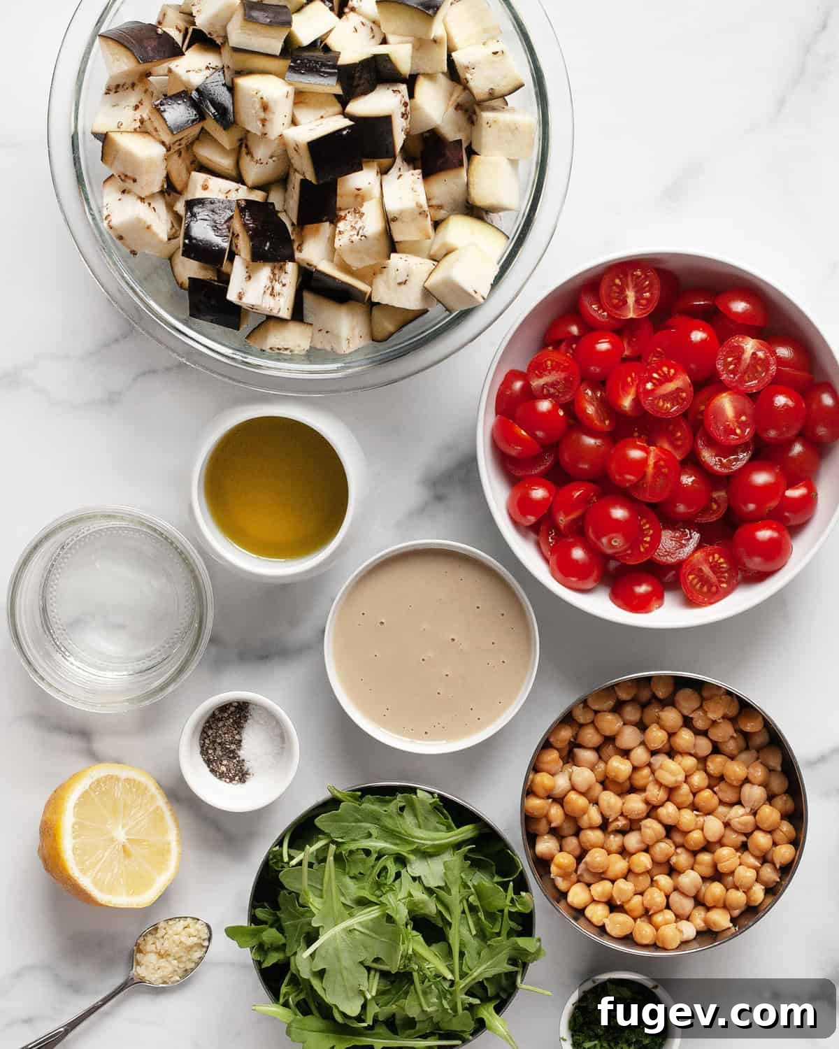 Zesty Lemon Tahini Roasted Eggplant with Chickpeas and Tomatoes 3 Ingredients including eggplant, tomatoes, chickpeas, arugula, tahini, lemon, parsley, salt and pepper.