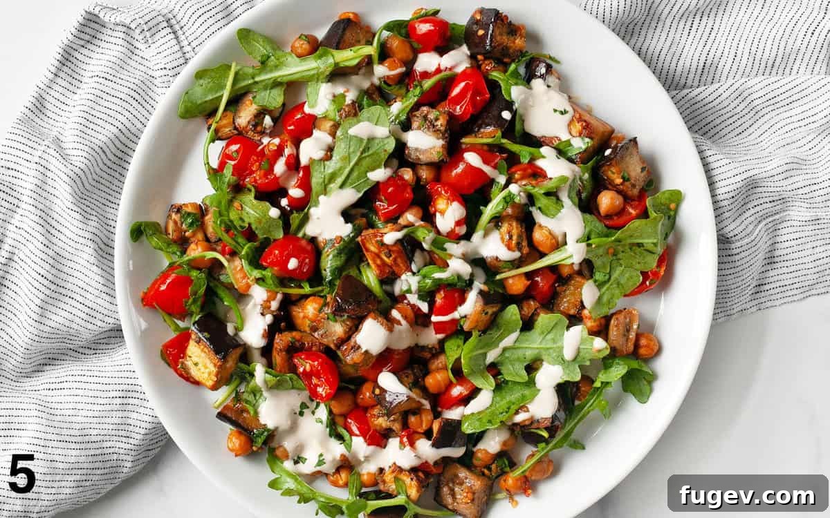 Zesty Lemon Tahini Roasted Eggplant with Chickpeas and Tomatoes 6 Assembled recipe on a plate.