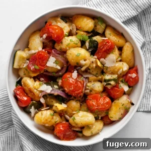 Sheet pan gnocchi with roasted vegetables in a bowl.