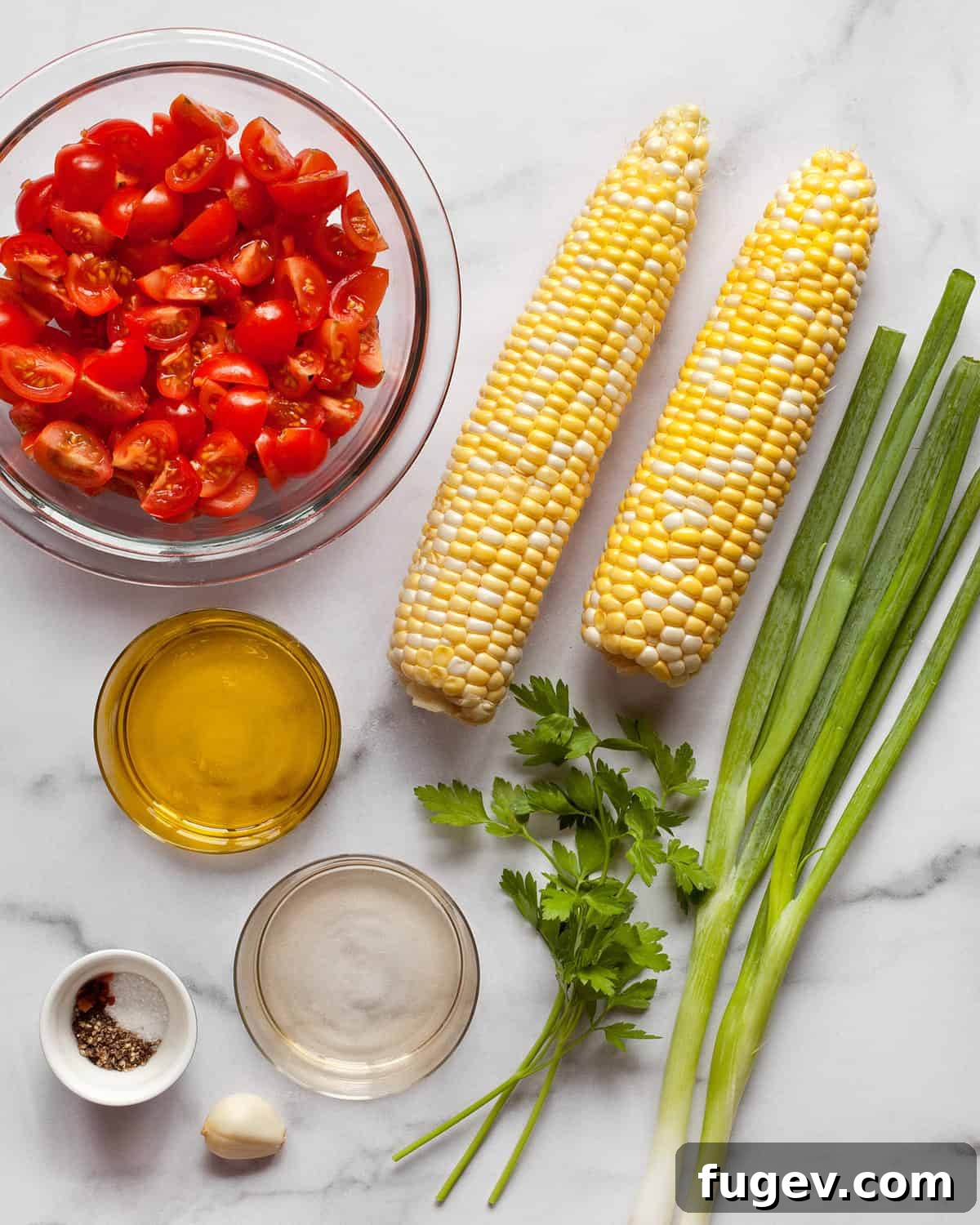 Vibrant Summer Corn and Tomato Salad 3 A vibrant flat lay of fresh ingredients including ripe tomatoes, raw corn kernels, chopped scallions, fresh parsley, olive oil, and white wine vinegar.