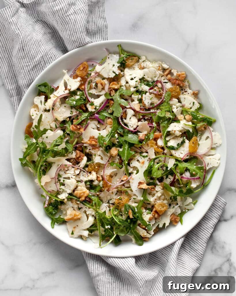 Crisp Cauliflower Salad with Walnuts and Tangy Pickled Raisins 7 Raw cauliflower salad on a plate.