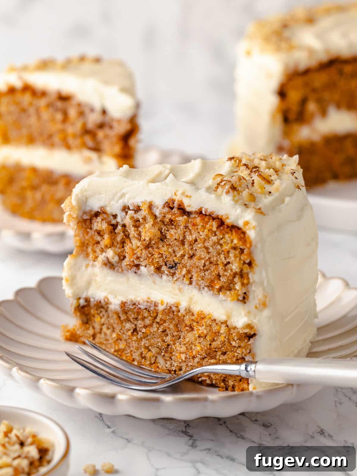 Irresistible Homemade Carrot Cake 2 A perfectly sliced piece of the best carrot cake, showcasing its moist interior, rich carrot flecks, and thick layers of tangy cream cheese frosting.