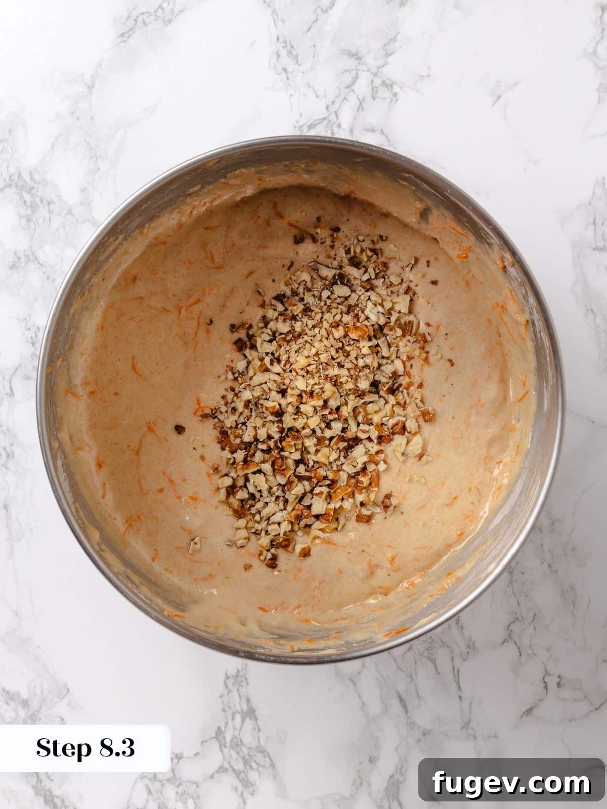 Irresistible Homemade Carrot Cake 12 Toasted and chopped walnuts being folded into the carrot cake batter, adding texture and nutty flavor.
