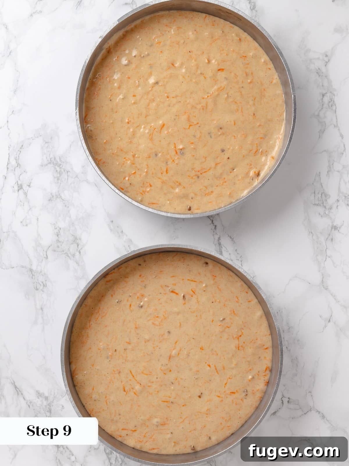 Irresistible Homemade Carrot Cake 14 Cake batter being evenly divided into two round baking pans, demonstrating proper portioning for balanced layers.
