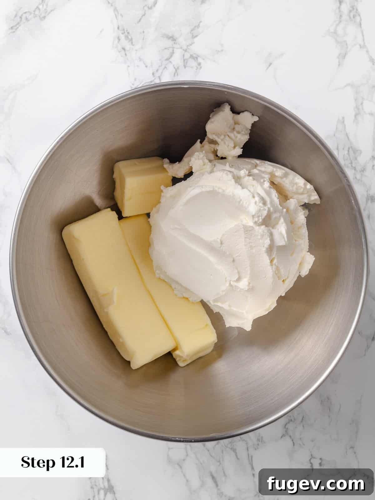 Irresistible Homemade Carrot Cake 16 Blocks of room temperature butter and cream cheese in a mixer bowl, ready to be blended into frosting.