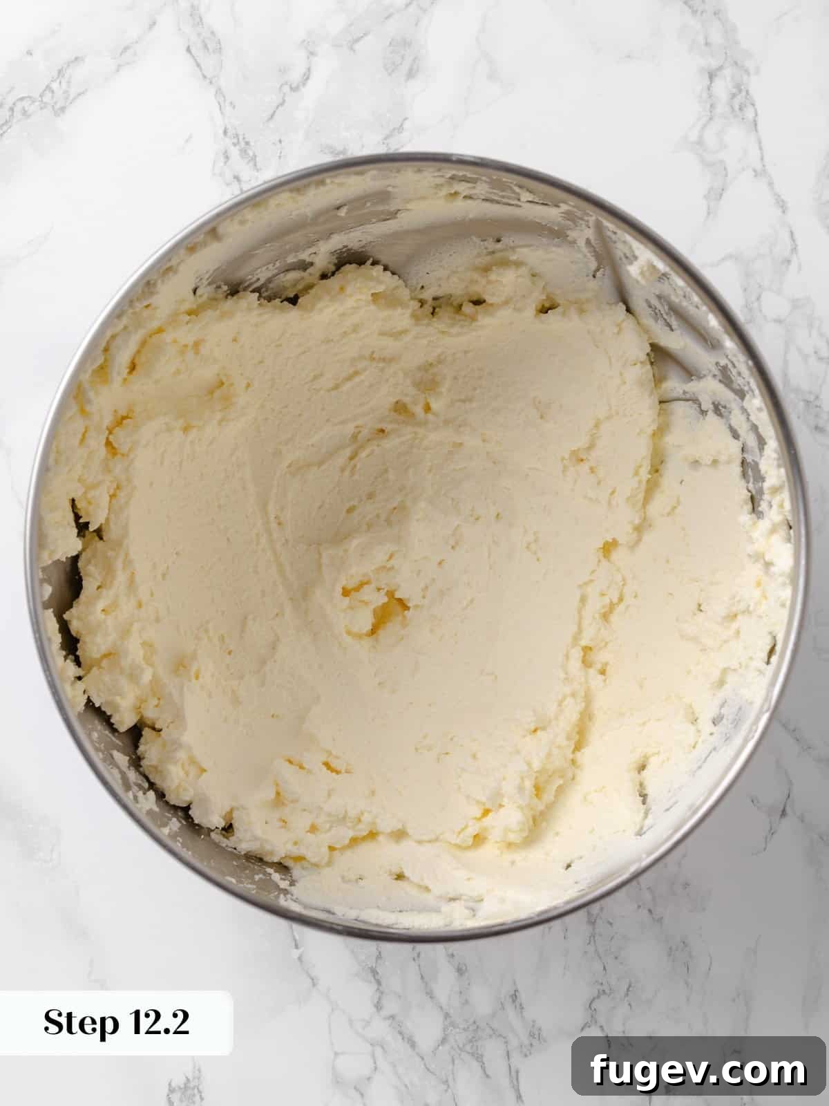 Irresistible Homemade Carrot Cake 17 The frosting base of butter and cream cheese, visibly aerated and smooth after blending in a mixer.
