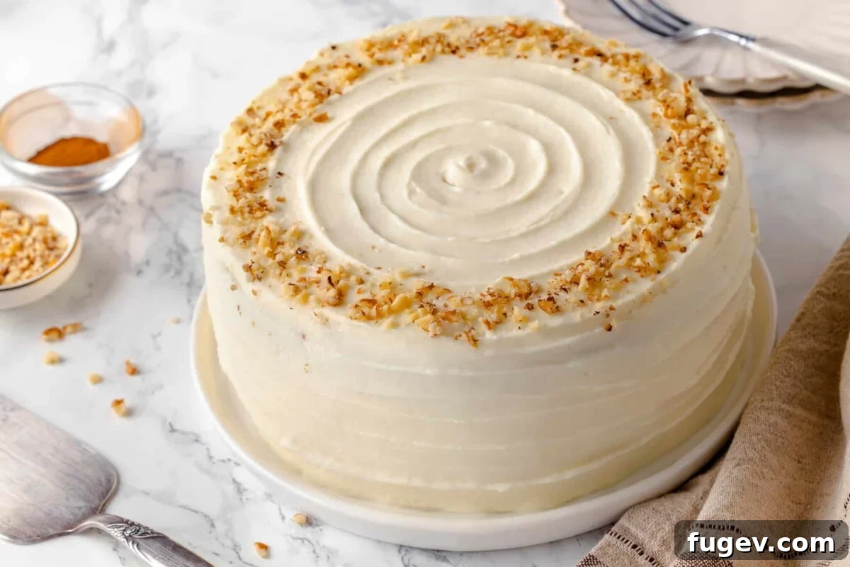 Irresistible Homemade Carrot Cake 3 A beautifully frosted whole carrot cake with a smooth swirl top, ready for serving.