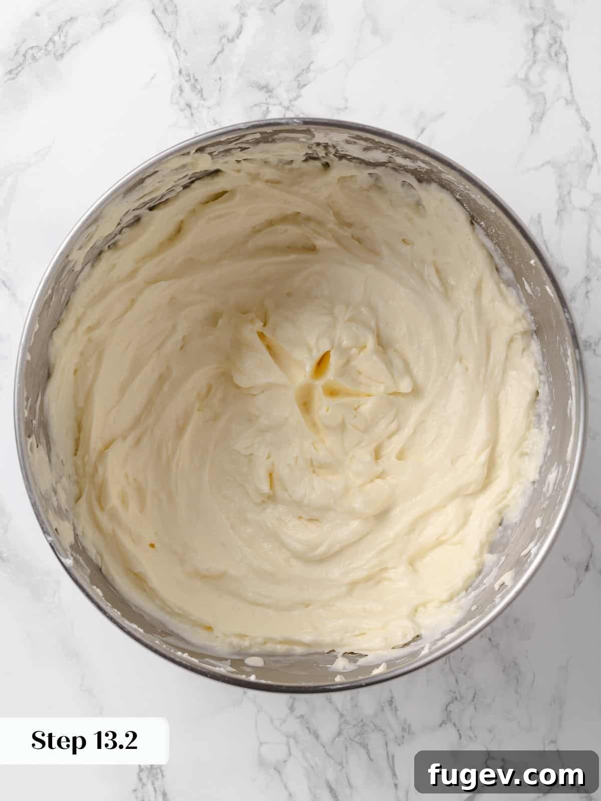 Irresistible Homemade Carrot Cake 21 A bowl of smooth, fluffy, and perfectly whipped cream cheese buttercream, ready for frosting the cake.