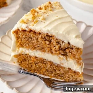Single slice of carrot cake served on a white plate.