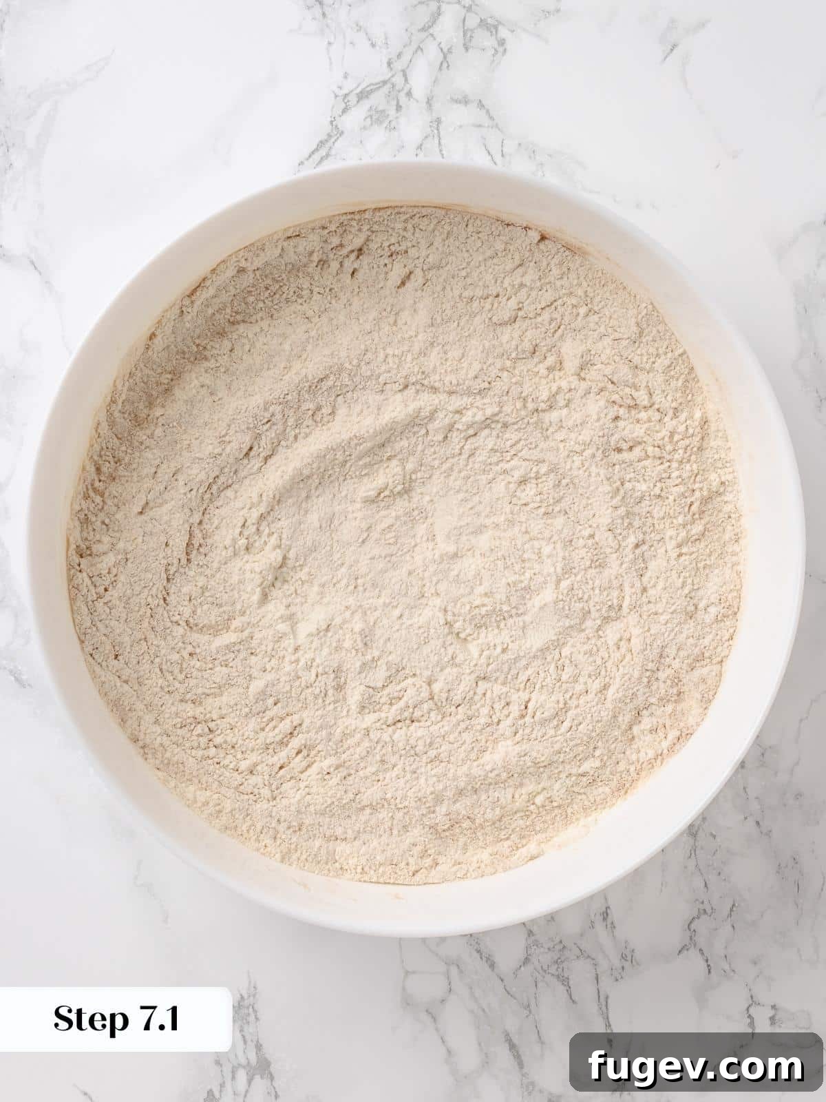 Irresistible Homemade Carrot Cake 8 A bowl filled with the dry ingredients: flour, baking soda, baking powder, cinnamon, and salt, perfectly mixed.