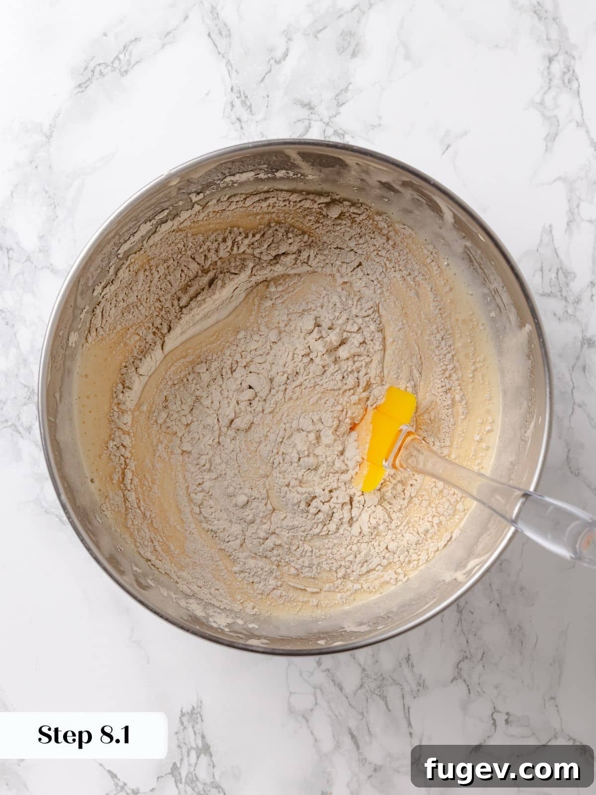 Irresistible Homemade Carrot Cake 10 Cake batter in a bowl, showing distinct streaks of flour, indicating it's not yet fully mixed to prevent overworking.
