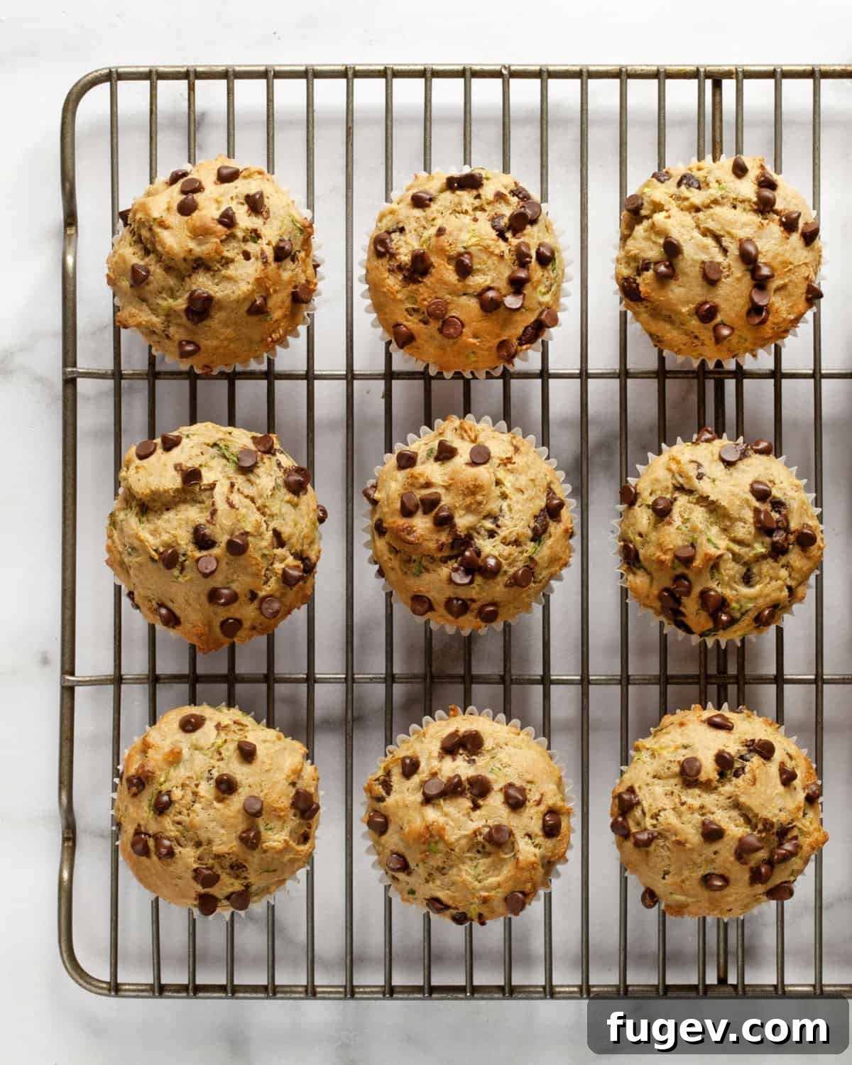 Wholesome Chocolate Chip Zucchini Delights 7 Nine perfectly baked zucchini muffins cooling on a wire rack.