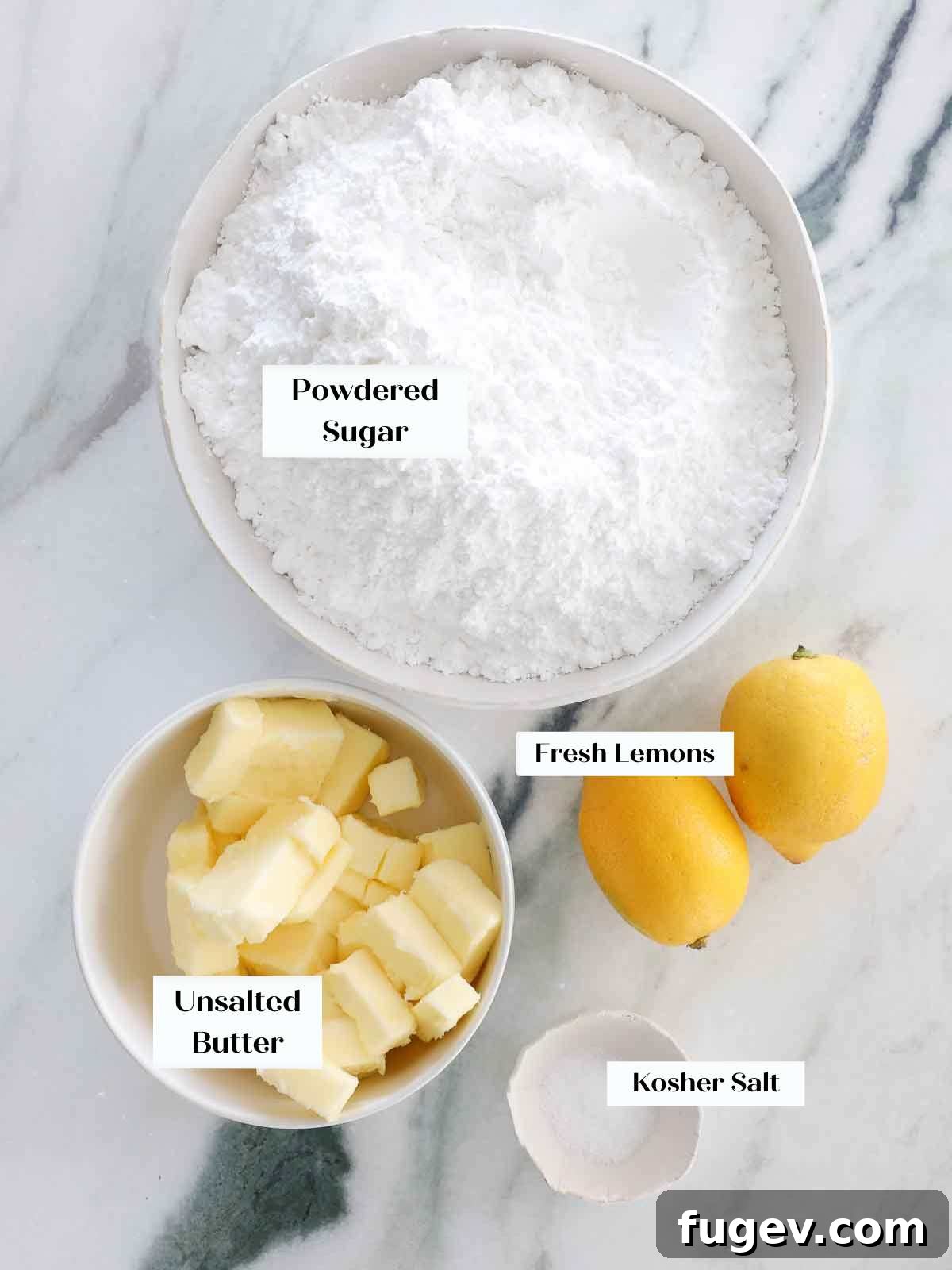 Sunshine Lemon Cloud Frosting 4 Bowl of unsalted butter, powdered sugar, kosher salt, and fresh lemons laid out as ingredients for lemon buttercream frosting.