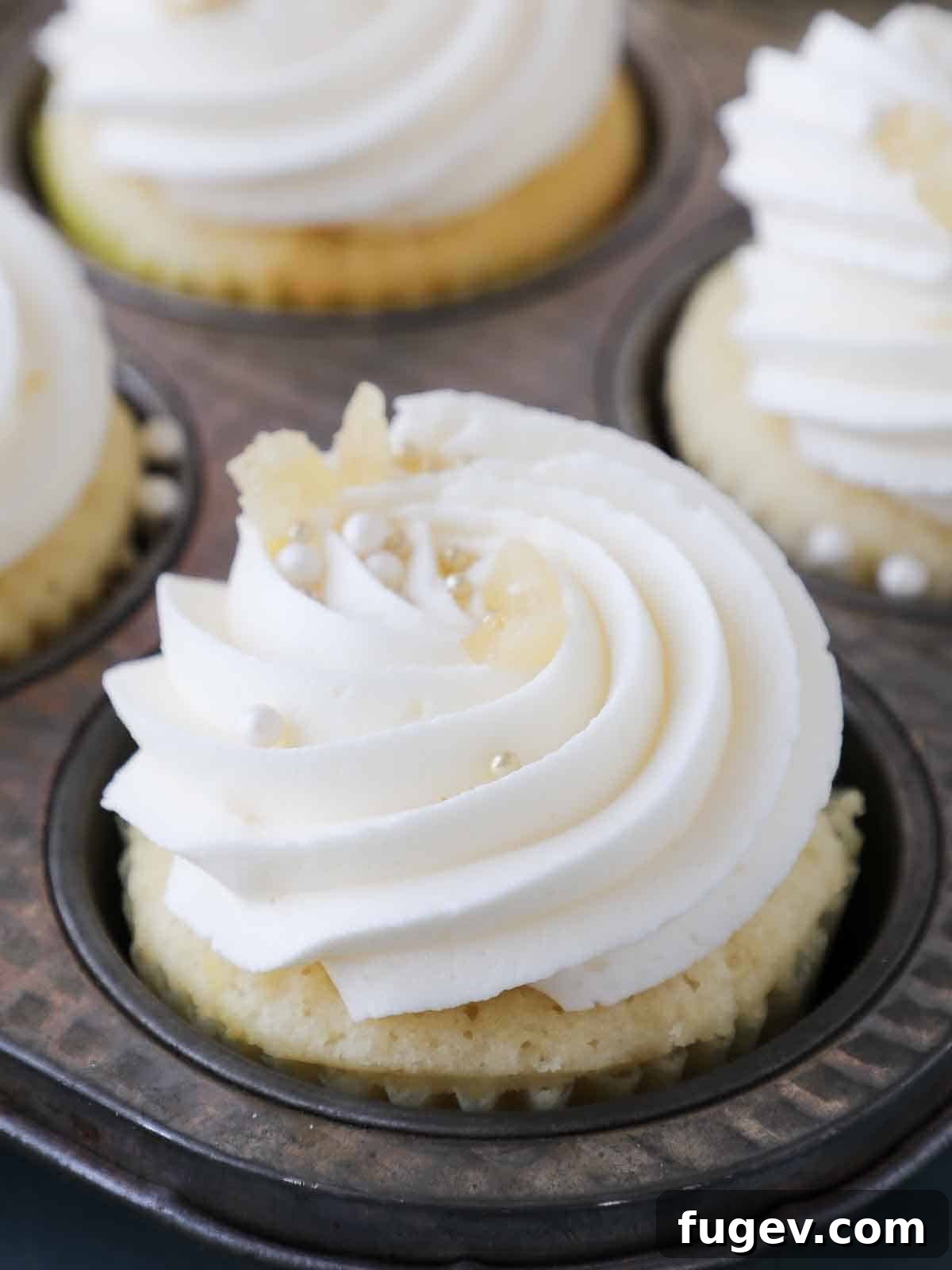 Sunshine Lemon Cloud Frosting 7 Piped lemon buttercream frosting on cupcakes, showcasing elegant swirls.