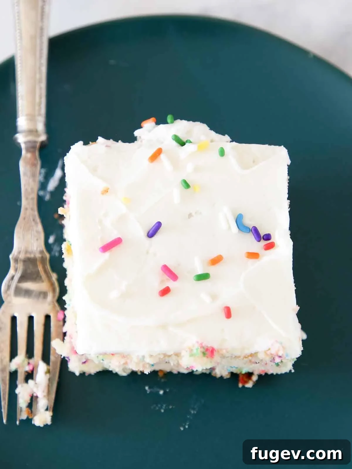 Sunshine Lemon Cloud Frosting 9 Lemon buttercream frosting spread smoothly on a sheet cake, with a simple decorative edge.