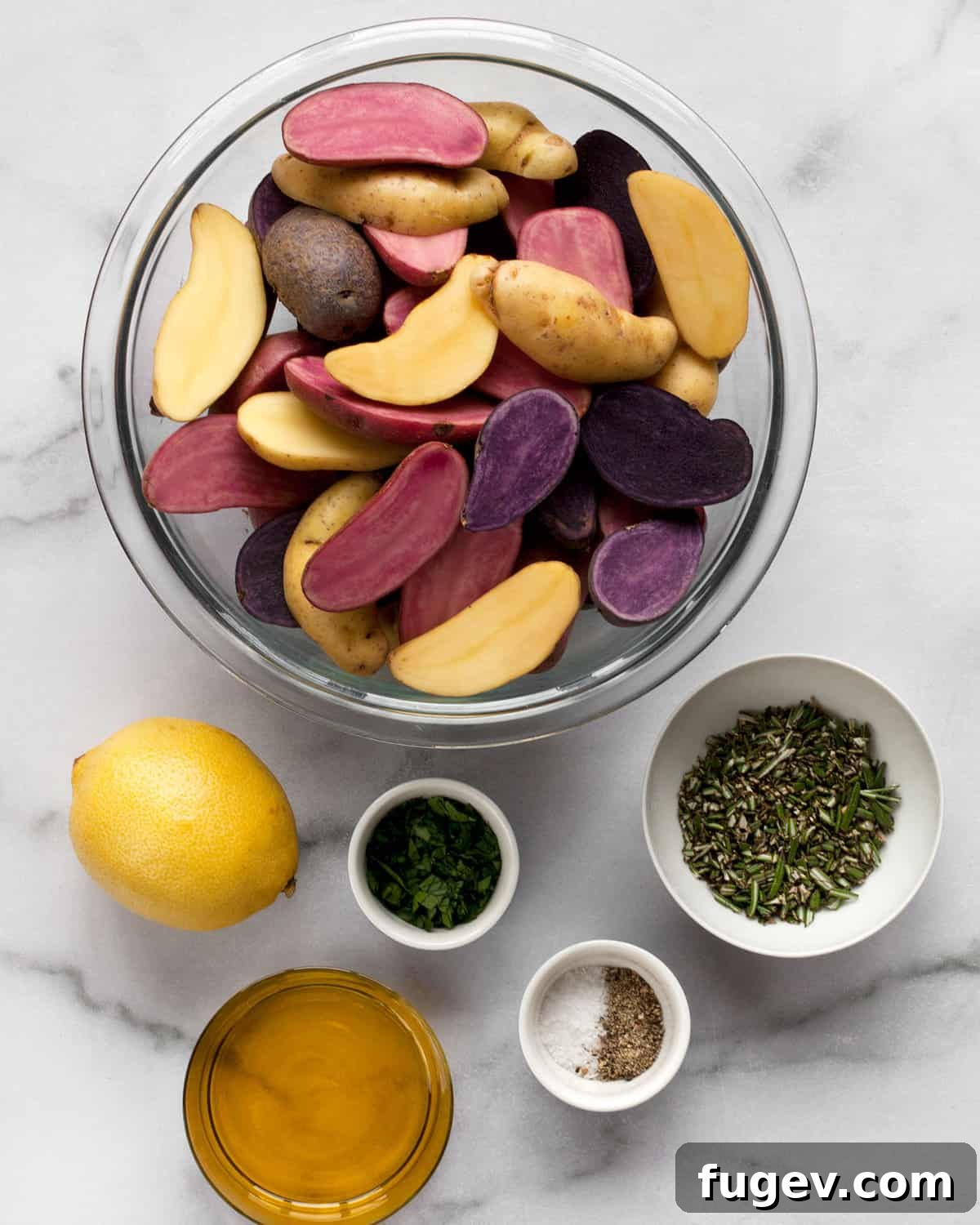 Ingredients for Lemon Rosemary Roasted Potatoes A collection of fresh ingredients for lemon rosemary roasted potatoes: fingerling potatoes, a lemon, olive oil, fresh rosemary, fresh parsley, and salt and pepper.