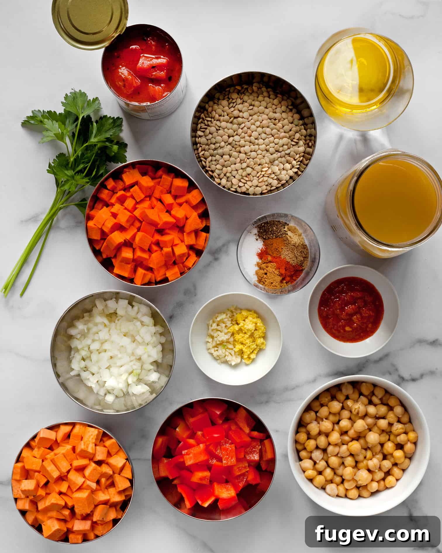 Spiced Slow Cooker Moroccan Chickpea Stew 4 Assortment of fresh ingredients for Moroccan Chickpea Stew including chickpeas, sweet potatoes, bell peppers, lentils, and tomatoes, ready for preparation.