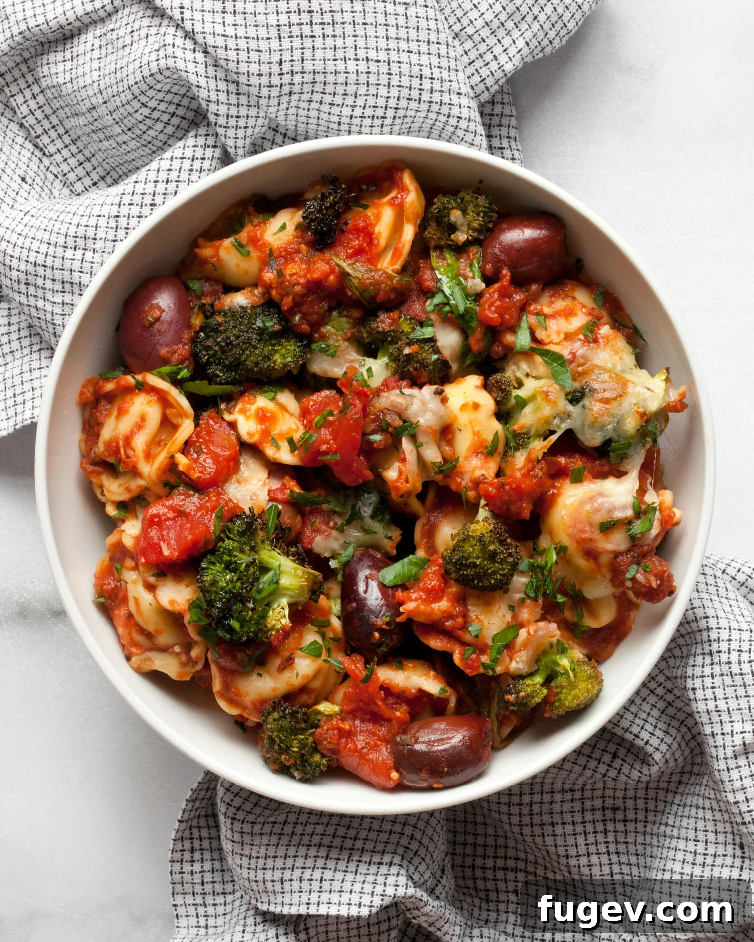 Mediterranean Tortellini Bake 2 Baked tortellini in a serving bowl, ready to be enjoyed.