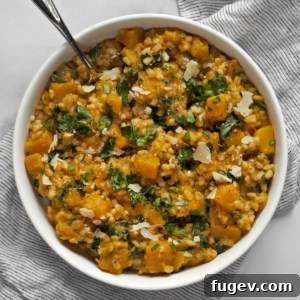 Velvety Baked Butternut Risotto 7 Baked butternut squash risotto in a bowl, garnished with fresh herbs.