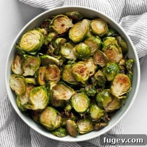 A bowl of freshly roasted crispy Brussels sprouts, garnished and ready to serve.