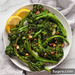 Toasted Almond Broccolini Sauté 7 Sauteed broccolini piled on a plate with lemon wedges.