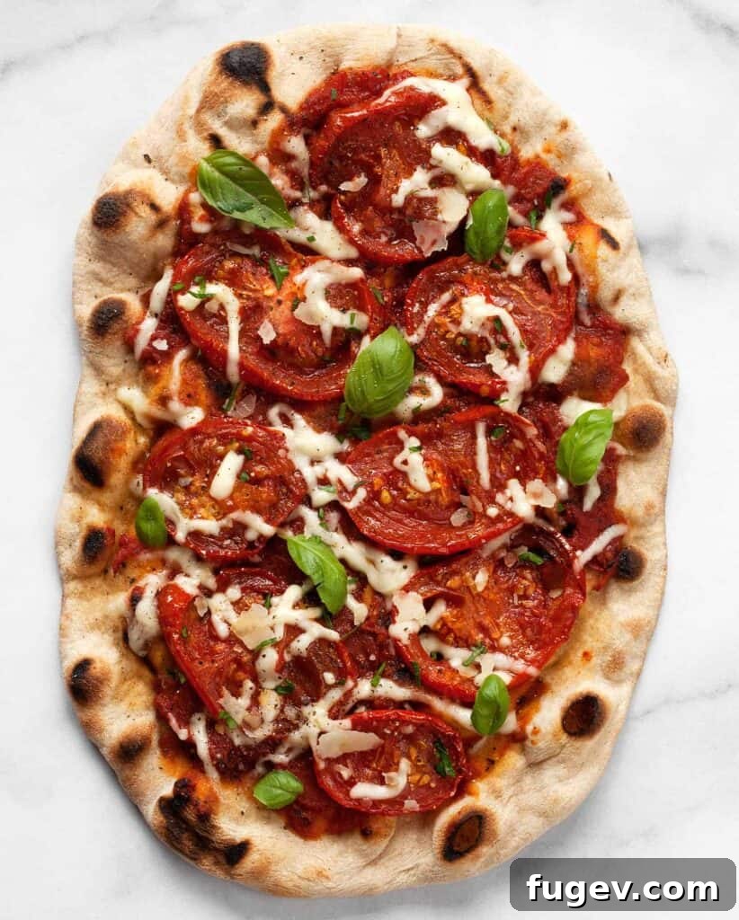 Crispy Grilled Pizza Delights 2 Grilled pizza with roasted tomatoes, showing a delicious, crispy crust with charred edges and vibrant toppings.